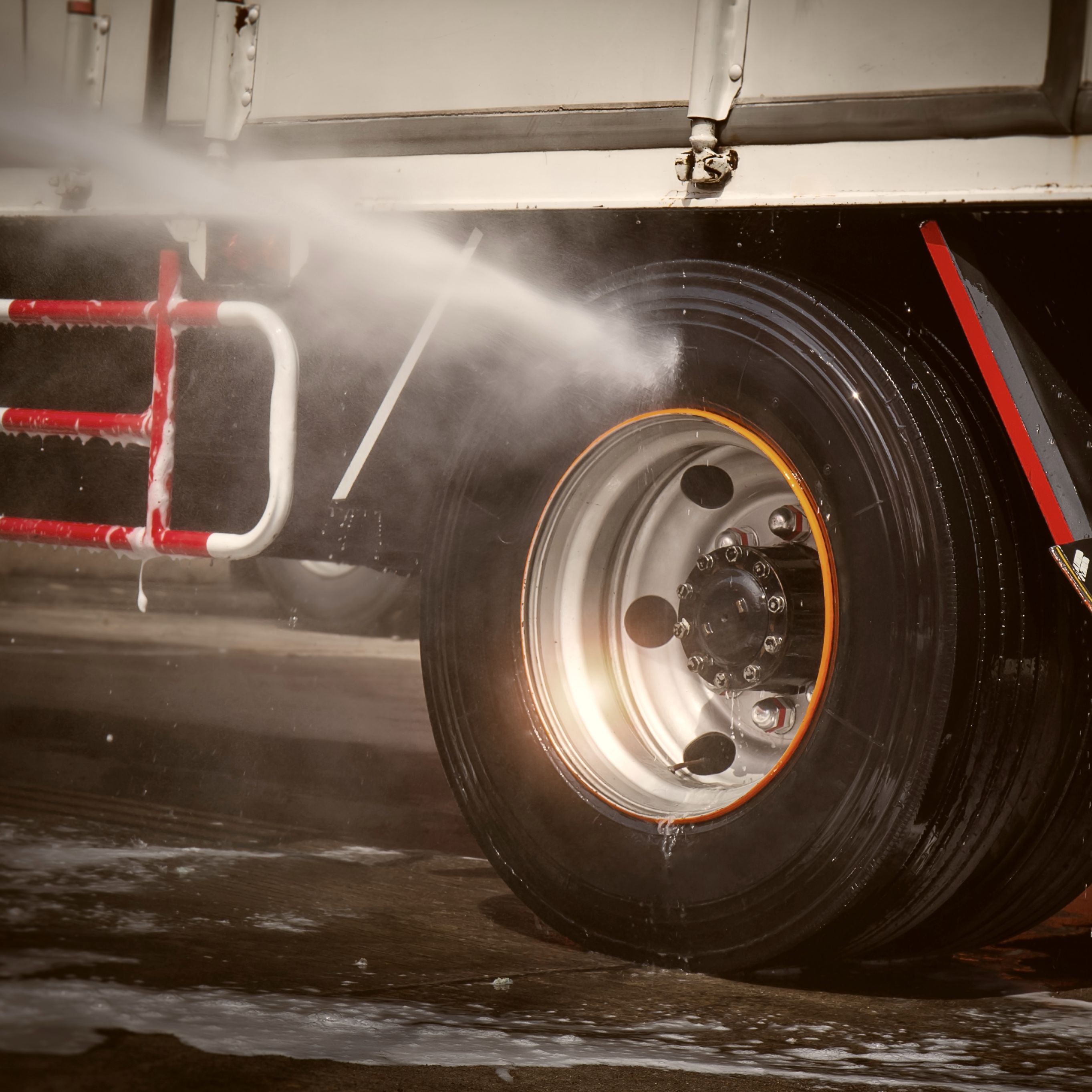 Photo of a tire being sprayed clean with Reeves tire shine for horse and stock trailers.